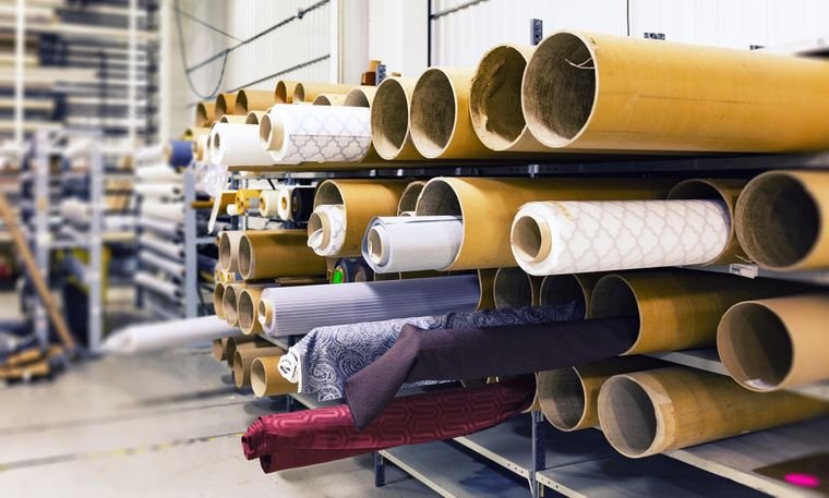 Rolls of cloth racked in a textile store room