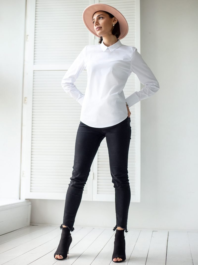 A crisp white cotton shirt worn with dark jeans